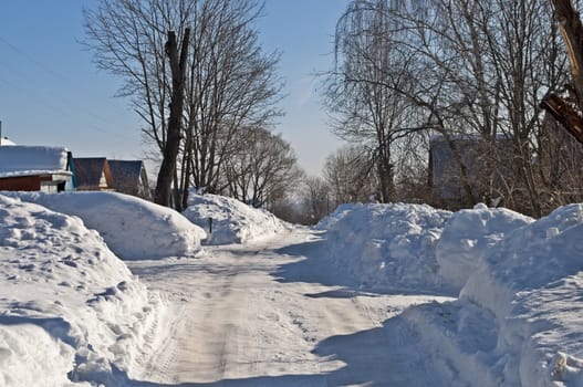 Drifts on the street in a Russian village