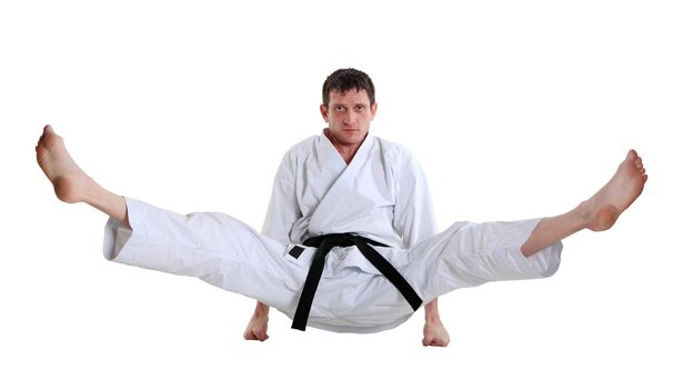 Karate. Man in a kimono with a white background