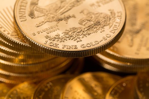 Stacks of gold eagle one troy ounce golden coins from US Treasury mint