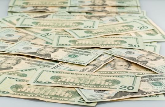 Background image of many twenty dollar bills or notes laid out on table and suitable for composites