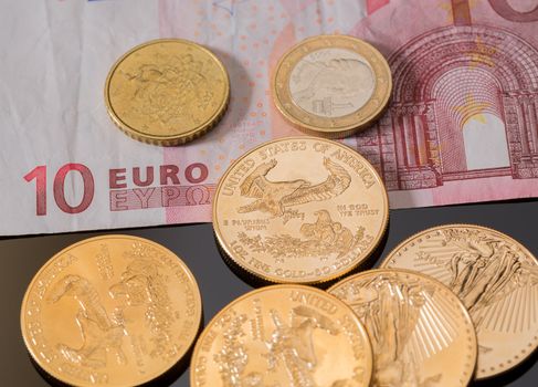 Solid gold coins contrasted with euro note and coins suggesting debt problems in Europe