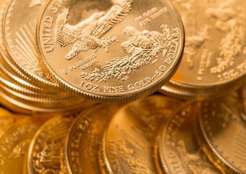 Stacks of gold eagle one troy ounce golden coins from US Treasury mint