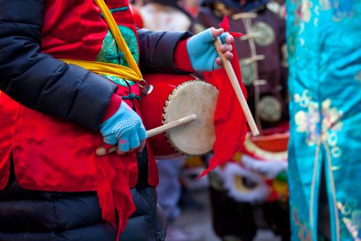 MILAN, ITALY - FEBRUARY 10: Child playing percussion in the Chinese New Year parade in Milan on February 10, 2013