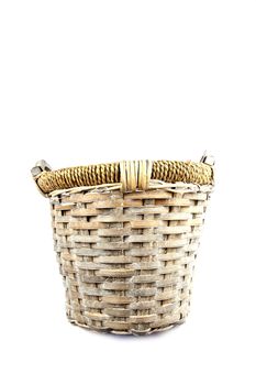 Old basket made of reed isolated on white background