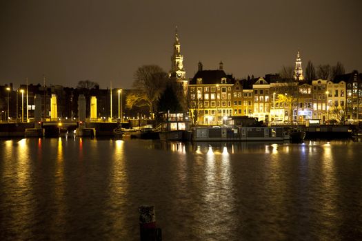 View at Amsterdam at night with canal and historic buildings
