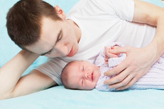 father gently embraces the chest baby