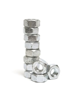 A stack of construction nuts isolated on white.