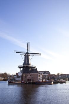 Classic windmill at canal in The Netherlands