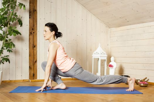 An image of a pretty woman doing yoga at home