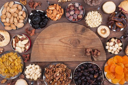 Wooden semi-circle, surrounded by nuts and fruits