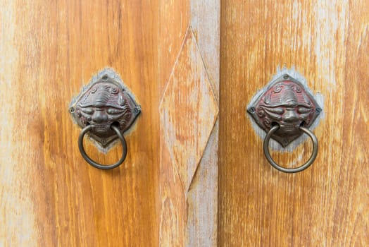 Old vintage chinese temple wooden door with metal chinese door handle