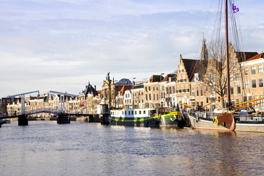 View at Dutch canal with old bridge, boats and churches at Haarlem, The Netherlands