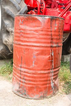 Red dirty rusty and damaged oil drum, taken up front