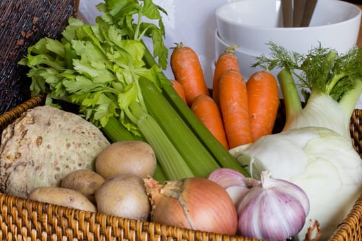 Composition with raw vegetables and wicker basket