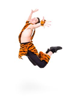 Wild man wearing a tiger fur jumping against isolated white background