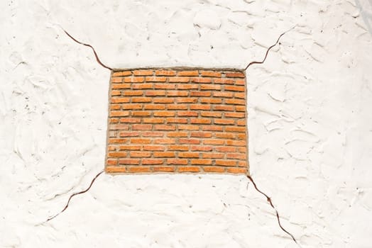 Red square shape brick on white background with cracks, taken outdoor.