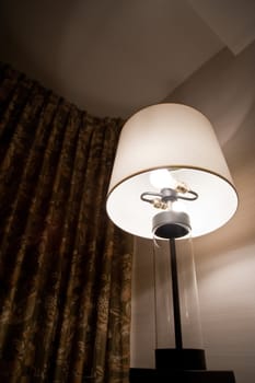 Lit lamp in a room