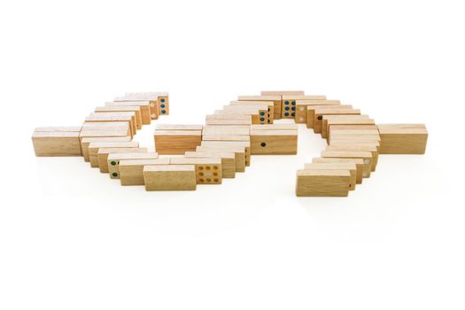 Symbol of dollar from wooden domino on white background