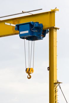 The hook of a construction crane against white background