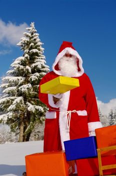 Santa Claus, Father Christmas with colorful presents on a sledge