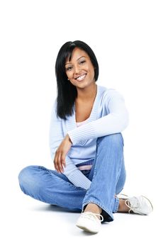 Relaxing black woman sitting on floor isolated on white background