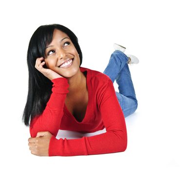 Portrait of black woman looking up smiling and laying on white background