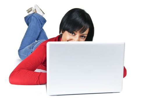 Smiling black woman peeking from behind computer laying on floor