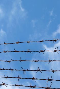 Barb wire fence and blue sky blackground