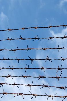 Barb wire fence and blue sky blackground