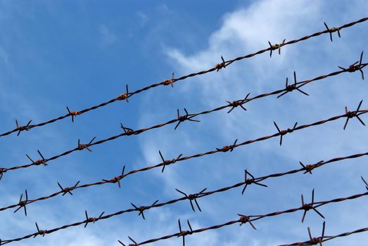 Barb wire fence and blue sky blackground