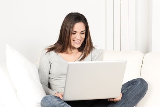 beautiful woman using laptop on sofa