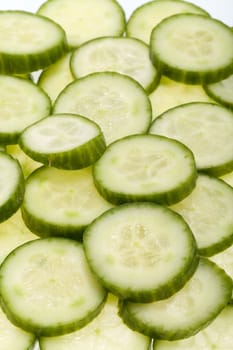 Freshly sliced cucumber  isolated on white background 