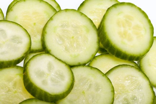 Freshly sliced cucumber  isolated on white background 
