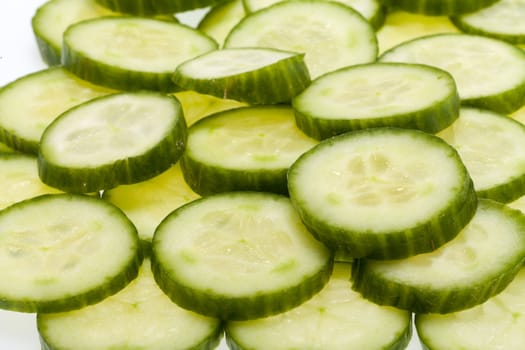 Freshly sliced cucumber  isolated on white background 
