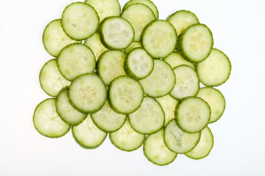 Freshly sliced cucumber  isolated on white background 