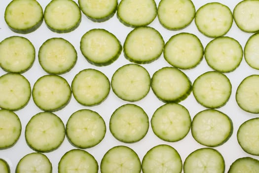 Freshly sliced cucumber  isolated on white background 