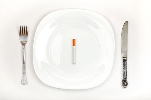 Concept of Cigarette on a Dinner Plate Instead a Food