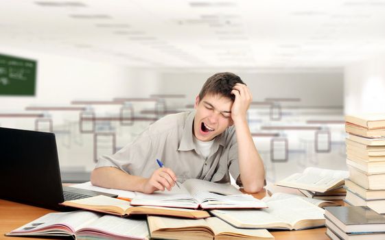 Bored Student is Yawning at the School Desk in the Classroom
