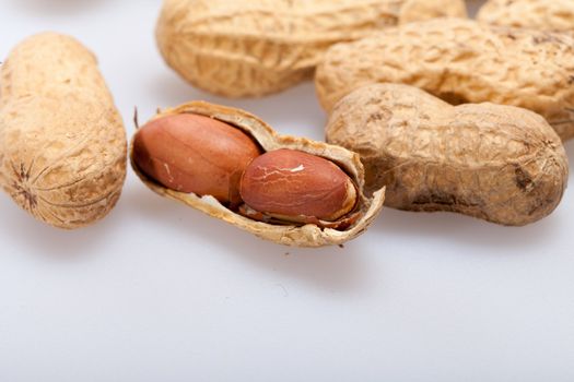 
Dried peanuts in closeup on the white background