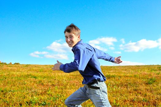 Happy Teenager Running Fast in the Autumn Field