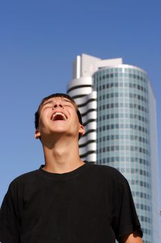 Happy Teenager on the glass building and blue sky background