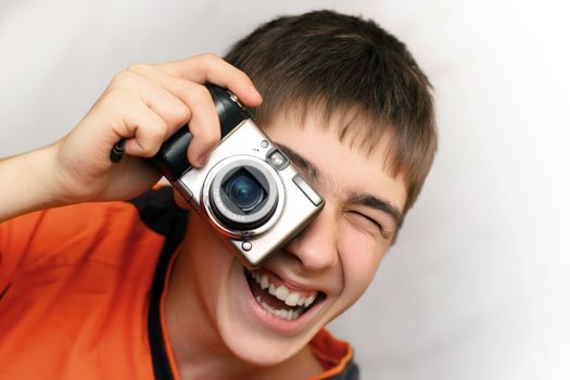 Excited Teenager with Photocamera gets ready to take a photograph