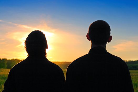 Two Persons silhouette on sunset background