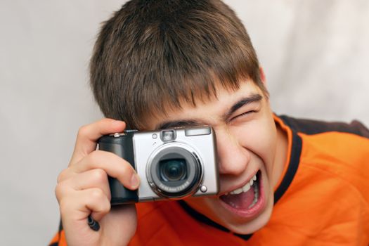 Excited Teenager with Photocamera gets ready to take a photograph