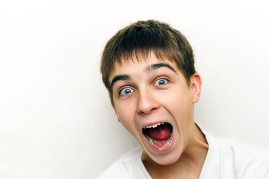 Surprised Teenager portrait with opened mouth on the White background