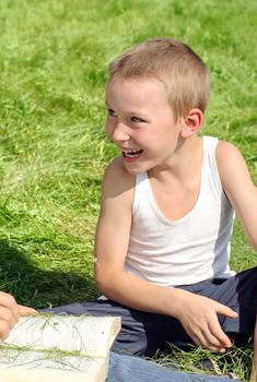 Happy Little Boy Laughing in the Summer Park