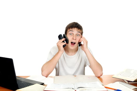 Surprised Young man with Three Mobile Phones at the school desk. Isolated on the white background