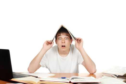 Surprised student at the school desk cover his head with exercise book