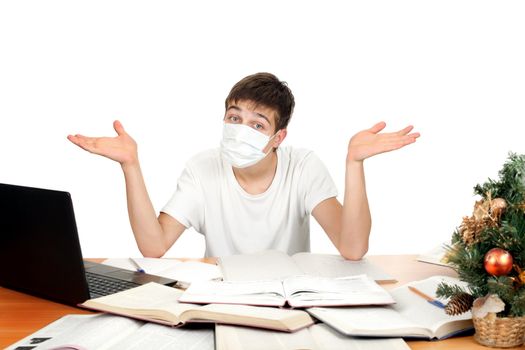 Student in flu mask spread his arms at the school desk. Isolated on the white background