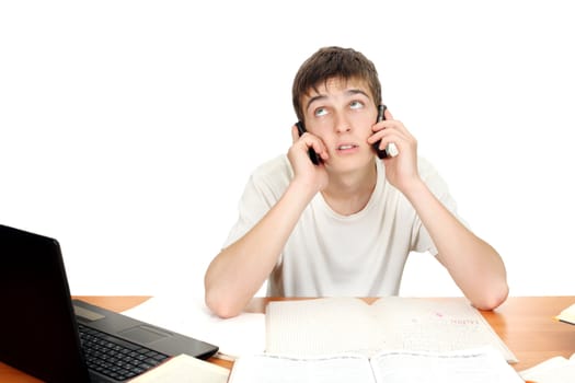 Dissatisfied Student with Two Mobile Phones at the school desk. Isolated on the white background